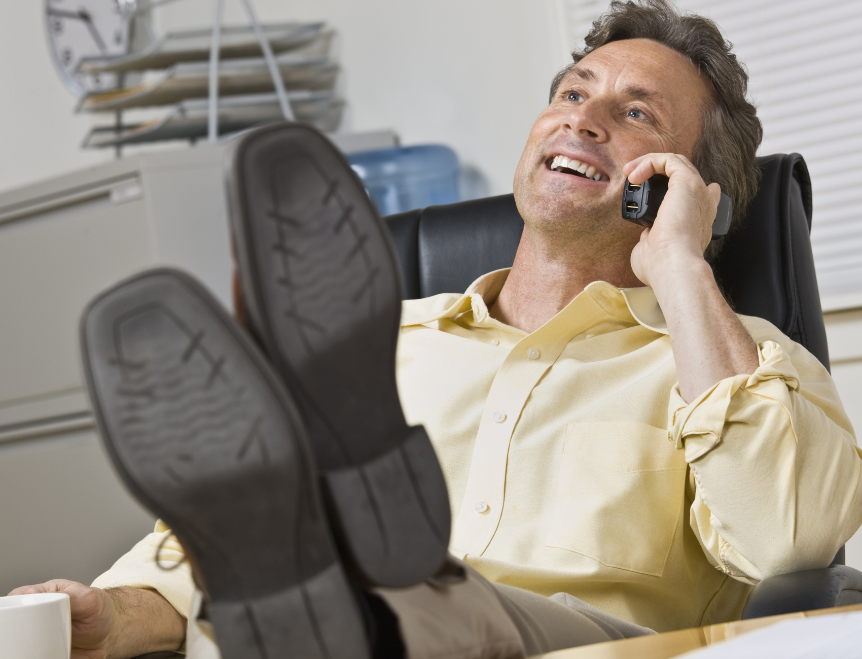 man talking on phone in his office